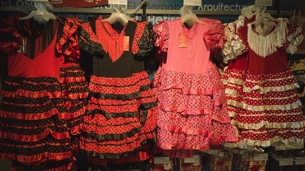 a bunch of dresses hanging on a rack