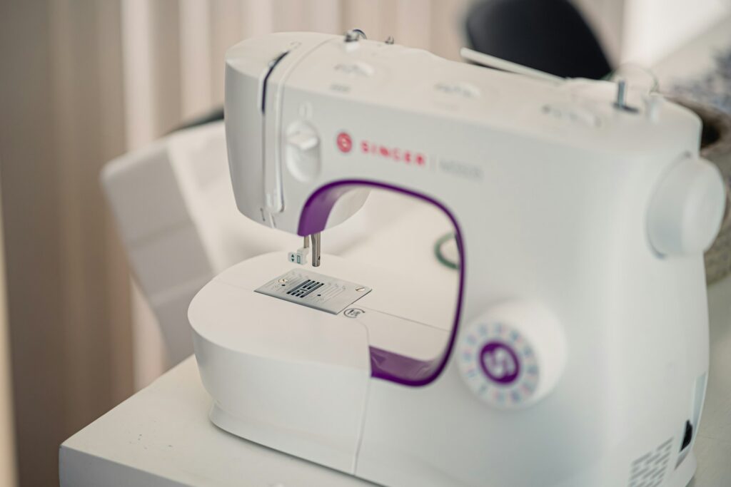 a white sewing machine sitting on top of a table